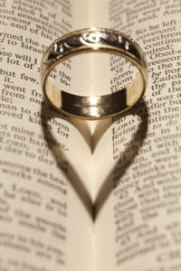 Romantic ring forming a heart on a bible